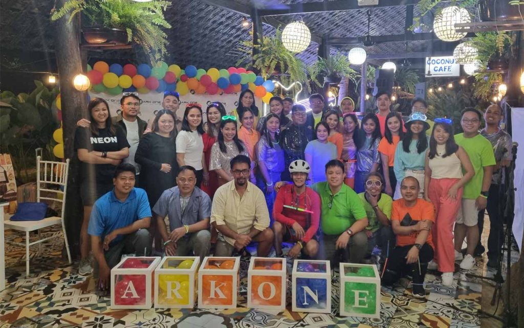Ark One Solutions' Christmas party featured employees dressed in Neon theme attire, mingling, and having a good time.